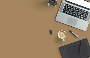 Office desk table with laptop computer, smartphone with black screen over a notebook and cup of coffee. Top view. photo