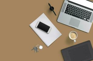 Office desk table with laptop computer, smartphone with black screen over a notebook and cup of coffee. Top view. photo