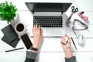 Overhead view of businesswoman working at computer in office photo