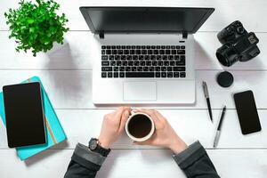 Overhead view of businesswoman working at computer in office photo