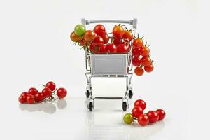 Mini shopping cart full with cherry tomatos on white background photo