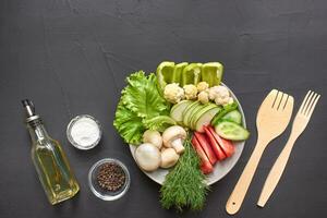 Top view of a fresh vegetables for healthy nutrition. Black background with copyspace. photo