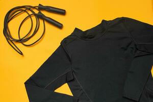 Close-up studio shot of a gym accessories on a yellow background. Top view, flat lay. photo