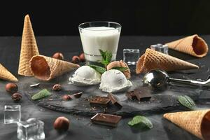 Gourmet chocolate and creamy ice cream served on a stone slate over a black background. photo