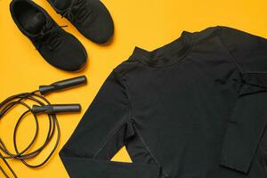 Close-up studio shot of a gym accessories on a yellow background. Top view, flat lay. photo