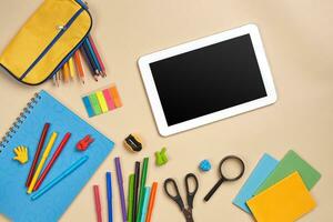 Flat lay photo of workspace desk with school accessories or office supplies.