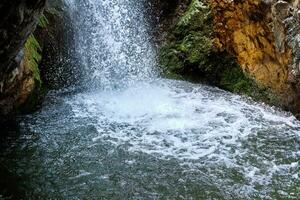 Close-up shot of a picturesque Millomeris waterfall and stream in the forest at Troodos mountains Cyprus, amazing natural landmark. photo