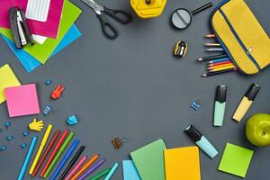 Flat lay photo of workspace desk with school accessories or office supplies.