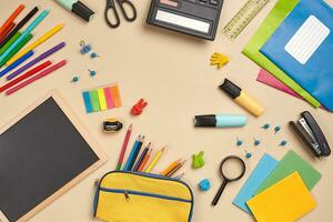 Flat lay photo of workspace desk with school accessories or office supplies.