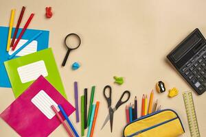 Flat lay photo of workspace desk with school accessories or office supplies.