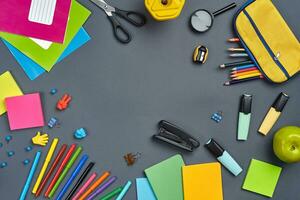 Flat lay photo of workspace desk with school accessories or office supplies.