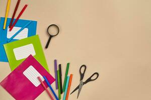 Flat lay photo of workspace desk with school accessories or office supplies.