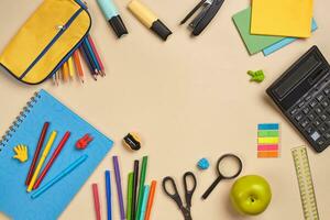 Flat lay photo of workspace desk with school accessories or office supplies.