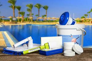 Equipment with chemical cleaning products and tools for the maintenance of the swimming pool. photo