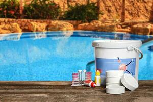 Equipment with chemical cleaning products and tools for the maintenance of the swimming pool. photo