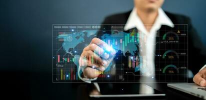 Business analysis technology, Businessman and finance analysis use digital tablets and computer notebooks to analyze financial graphs, stock market reports, and economic graph growth charts photo