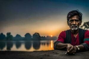 un hombre sentado en el suelo cerca un lago a puesta de sol. generado por ai foto