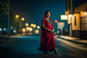 a woman in a red sari walks down the street at night. AI-Generated photo