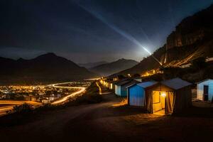 a night shot of a mountain village with lights shining on the buildings. AI-Generated photo