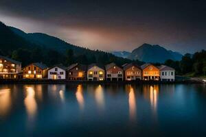 casas en el lago a noche con montañas en el antecedentes. generado por ai foto