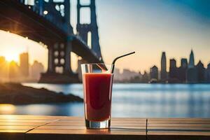 a glass of juice with a straw on a table in front of a bridge. AI-Generated photo