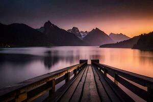 a wooden pier leads to a lake and mountains at sunset. AI-Generated photo