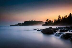 a long exposure photograph of a rocky shoreline and trees at sunset. AI-Generated photo