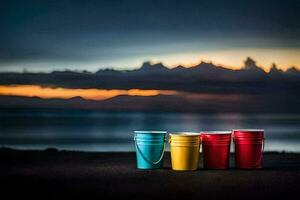 four colorful buckets sit on the beach at sunset. AI-Generated photo