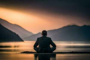 a man in a suit sits in meditation on the shore of a lake. AI-Generated photo