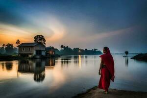 a woman in a red sari stands on the shore of a lake at sunset. AI-Generated photo