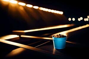 a bucket of popcorn sitting on a table in front of lights. AI-Generated photo