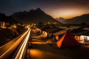 a long exposure photo of a road and tents in the mountains. AI-Generated