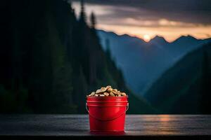 a red bucket of peanuts on a table in front of a mountain range. AI-Generated photo