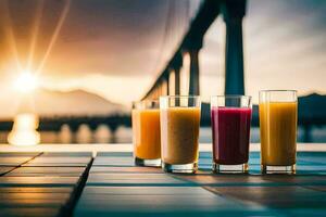 four glasses of juice on a table with a bridge in the background. AI-Generated photo