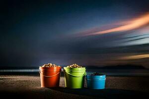 Tres cubos de arena en el playa a noche. generado por ai foto