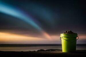 a bucket of rocks sitting on the beach with an aurora in the background. AI-Generated photo