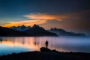 un hombre en pie en un rock en frente de un lago a puesta de sol. generado por ai foto
