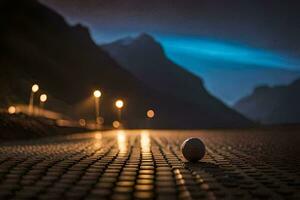 un pelota se sienta en el la carretera en frente de un montaña. generado por ai foto