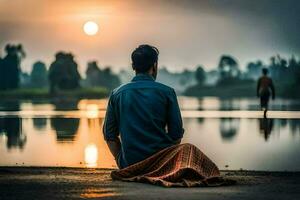 a man sitting on the ground near a lake at sunset. AI-Generated photo