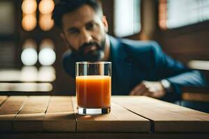 un hombre sentado a un mesa con un vaso de naranja jugo. generado por ai foto