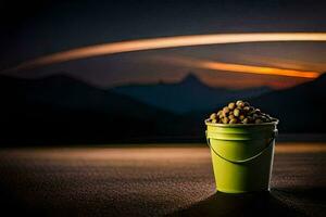 a bucket of food sitting on the ground in front of a mountain. AI-Generated photo