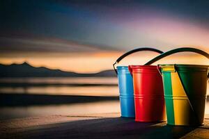 three colorful buckets sitting on the beach at sunset. AI-Generated photo