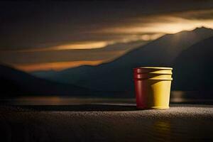 a red and yellow cup sitting on a table in front of a lake. AI-Generated photo