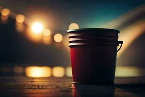 a red bucket sitting on the ground in front of a bridge. AI-Generated photo