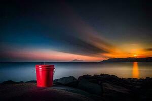 un rojo Cubeta se sienta en el rocas a puesta de sol. generado por ai foto