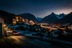 un coche unidades abajo un la carretera en frente de un montaña pueblo a noche. generado por ai foto