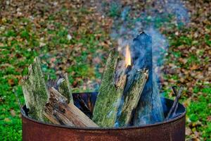 a fire pit with logs and sticks in it photo