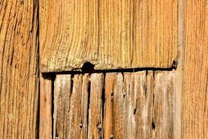 a close up of a wooden wall with a hole photo