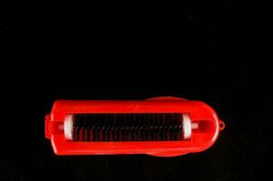 a red razor with a black handle photo