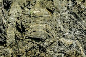 a rock face with many different types of rocks photo